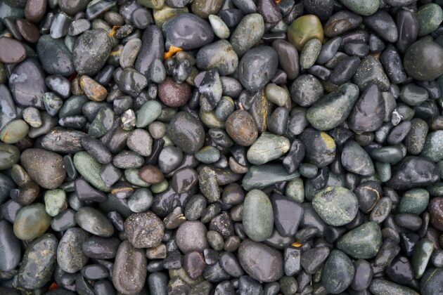 Knowing how to clean landscape rock helps homeowners get results like this freshly rinsed gravel.