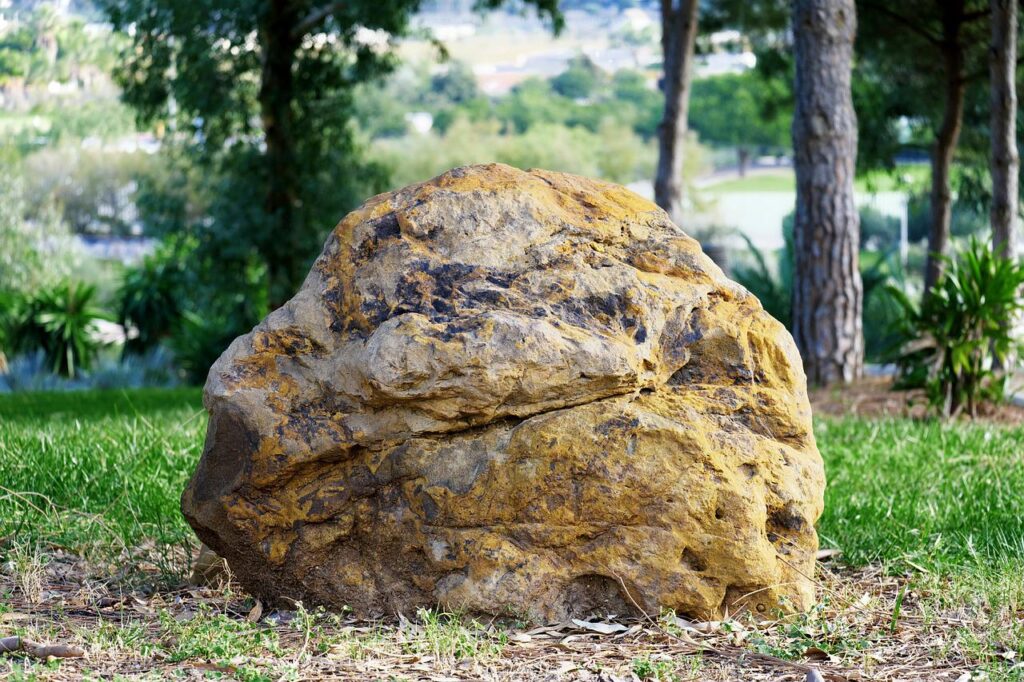 Some homeowners will like the aged patina on this boulder, and others will prefer it cleaned of moss and lichens.