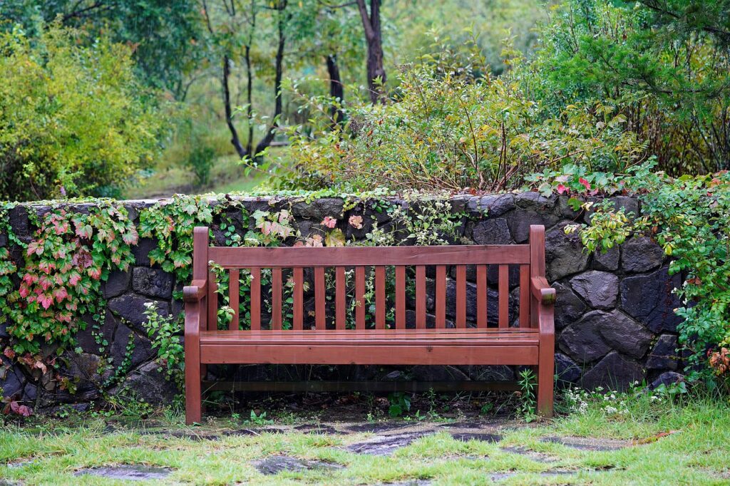 A bench is a creative way to add outdoor entertaining space when landscaping along fences. 