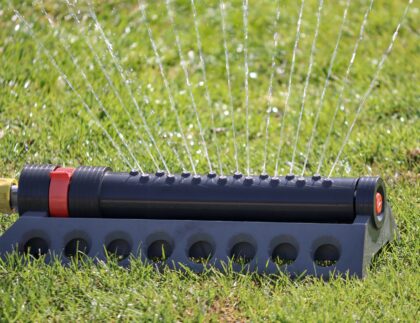 One of the best low maintenance landscaping ideas is to automate your sprinkler system and move away from manual ones like the one pictured.