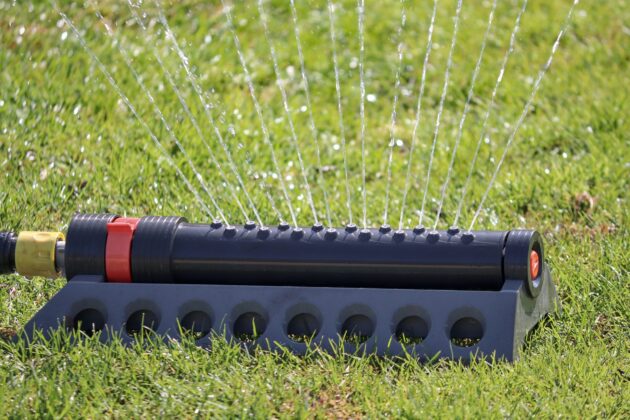 One of the best low maintenance landscaping ideas is to automate your sprinkler system and move away from manual ones like the one pictured.