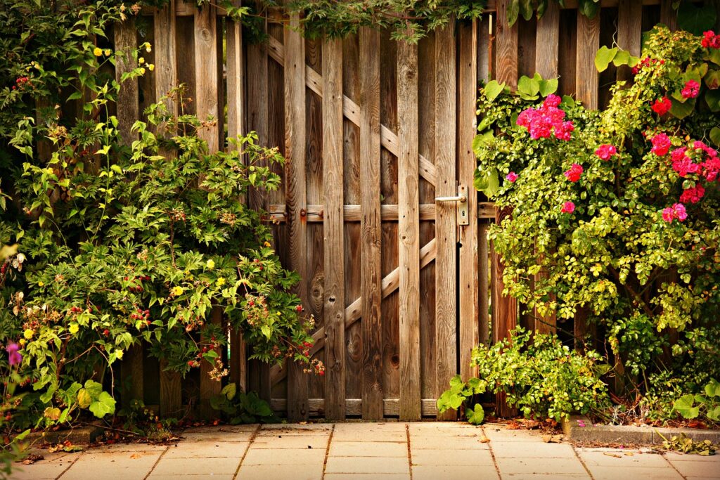 This side yard is designed with climbing perennials and a diversity of textural elements including wood and brick.