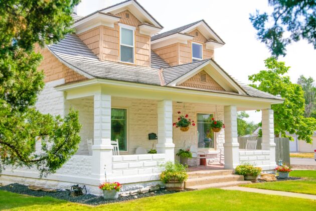 Automatic sprinklers, mulch, and the right tree choices result in low maintenance front yard landscaping for this sunny bungalow home.