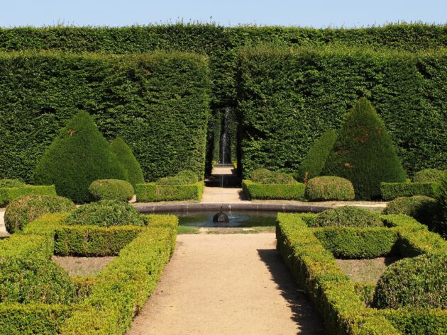 Elegant boxwood landscaping graces this French country-style courtyard.