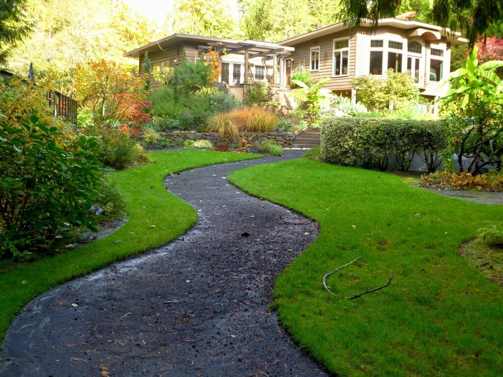 Prices of landscaping materials vary wildly, an asphalt walkway (shown) will cost less than a custom brick one, for example.