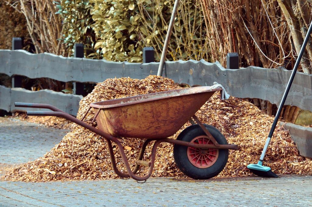 Using a wheelbarrow (like the one shown here) makes it easy to apply mulch all around the yard.